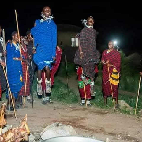 Maasai warriors performing a traditional jumping dance at night