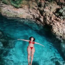 The lush green entrance to Kuza Cave in Zanzibar