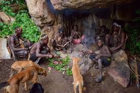 A tourist learning traditional archery with members of the Hadza tribe